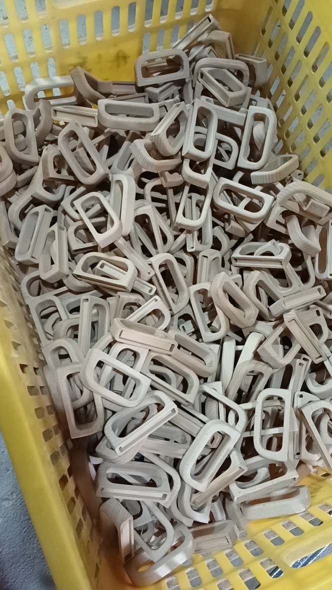 Wooden handles prepared for custom stainless steel coffee mug production